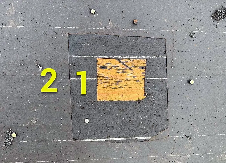 A numbered test square marked out on a roof for an insurance inspection